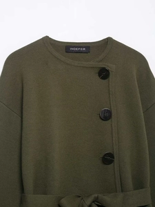 Detail of army green knit cardigan with black buttons and matching waist belt tie
