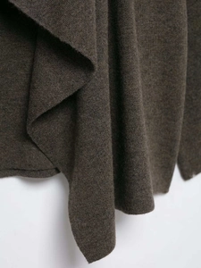 Detail shot of heavy dark brown knit fabric showing soft folds and fine needlework