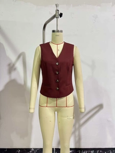 Detailed view of women's slim-fit burgundy waistcoat with V-neck and classic buttons