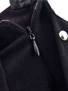 Detail view of the black wide-leg trousers featuring a silver button and invisible zipper