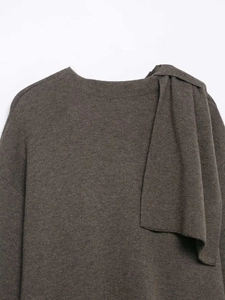 Detail of dark brown knit coat with integrated scarf collar and soft wool texture