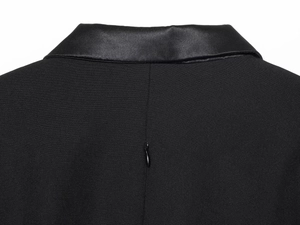 Detail of elegant black dress showing satin lapel back and hidden zipper closure