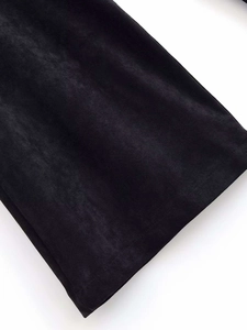 Detailed macro view of premium black velvet fabric texture with soft glossy finish