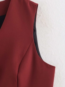 Detail of burgundy vest shoulder stitching and black lining with premium woven fabric