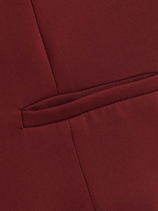 Detailed close-up of a classic welt pocket on a wine red slim fit vest