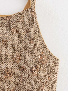 Detailed macro view of brown tweed fabric with bronze sequins and yellow lining
