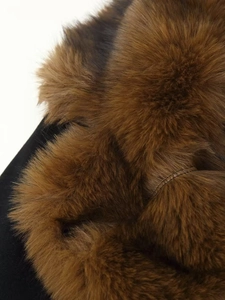 Close-up of soft brown faux fur texture and dense wool fibers on winter coat collar