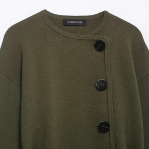 Olive green knit cardigan with asymmetrical button closure and smooth texture