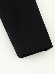 Close-up of high-quality wool texture and neat cuff stitching on a black winter coat