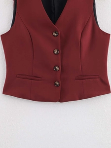 Detailed close-up of wine red slim fit vest featuring V-neck and four-button closure