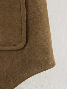 Detailed close-up of brown faux suede shirt jacket showing fine stitching and hem