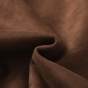 Detailed macro view of the premium brown faux suede fabric texture on motorcycle jacket