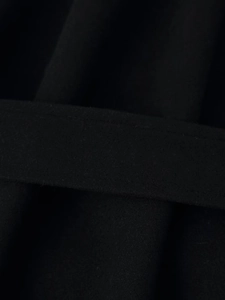 Detailed macro view showing the texture of thick black wool fabric and waist belt detail
