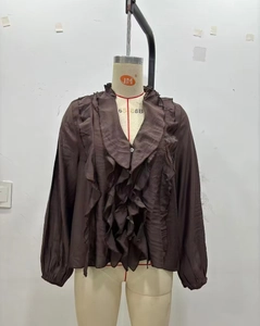 Detail of coffee brown long sleeve shirt with layered ruffles and elegant V-neckline