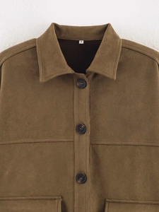 Close-up of brown faux suede shirt jacket featuring classic collar and marble buttons