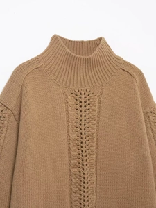Detail of taupe knit sweater with center openwork cable pattern and ribbed mock neck