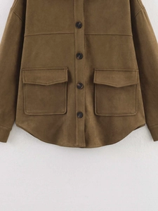Detail of dark brown faux suede jacket featuring symmetry flap pockets and curved hemline
