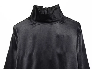 Detail showing the glossy black satin fabric and high collar design of the dress