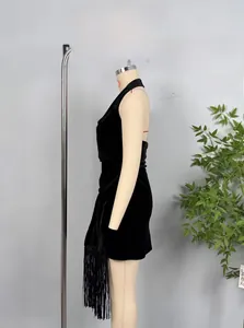 Detail view of black velvet halter dress featuring elegant long fringe hemline decoration