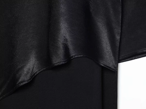 Detailed view of the slim-fit dress showing glossy satin and matte black fabric textures
