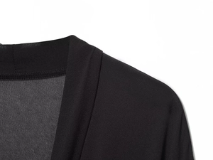 Detailansicht des schwarzen Kleidausschnitts mit eleganten Lagen und Texturstoff