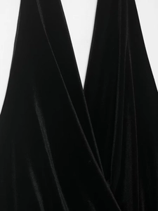 Detail of premium black velvet fabric showing deep V-neckline and elegant soft draping