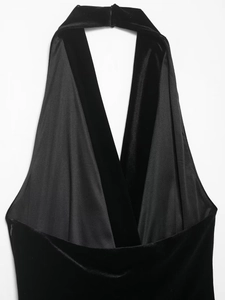 Detail view of the deep V-neckline on a velvet dress with premium satin trimming