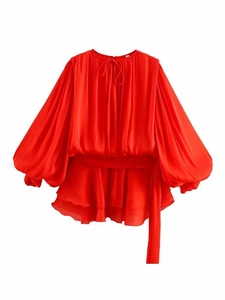 Detail of red lantern sleeves and layered ruffle hem on lightweight chiffon dress