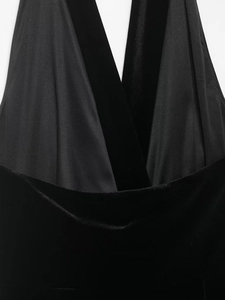 Detail of velvet and satin patchwork on black halter dress with deep V-neckline