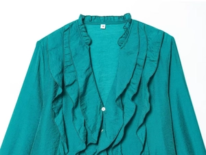 Detail of ruffled V-neckline and S-size label on silk-like teal long sleeve blouse