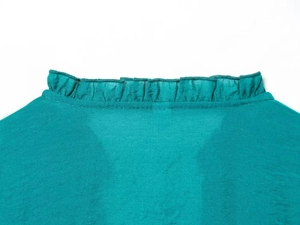 Detail of ruffled stand-up collar on turquoise long-sleeved blouse for women