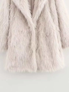 Close-up of high-quality faux fur texture and wide lapel on light beige winter coat