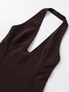 Detail of dark chocolate V-neck halter dress with backless design in woven fabric