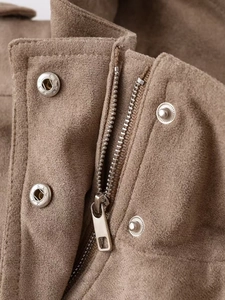 Detail of brown faux suede jacket featuring silver metal zipper and star embossed buttons