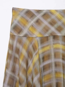 Detailed close-up of high-waisted plaid midi skirt with artistic watercolor checkered pattern