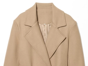 Detail of classic notched lapel on camel wool coat with premium textured fabric finish
