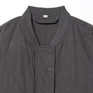 Deep grey quilted bomber jacket with wavy stitching and ribbed stand collar design