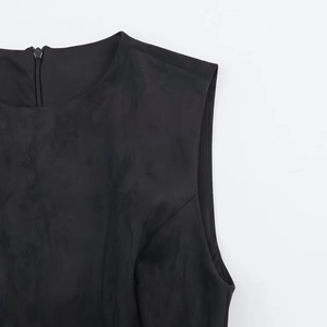 Detail of a black sleeveless velvet dress featuring a round neck and back zipper closure