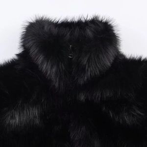 Women's chic black faux fur jacket with high collar and sleek metal zipper detail