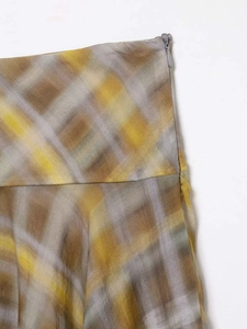 Detailed close-up of high-waist plaid midi skirt with a hidden side zipper closure
