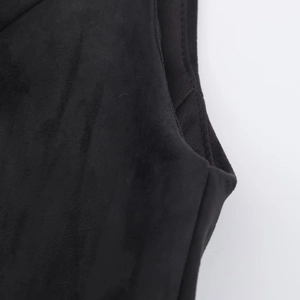 Macro detail of the black suede dress showing the neat rib knit trim and premium stitching