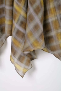 Detail shot of lightweight plaid fabric showing elegant texture and fine rolled edges