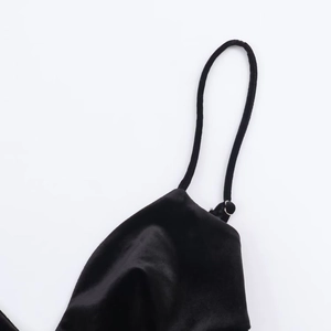 Close-up of black velvet dress shoulder strap showing premium soft texture and fabric