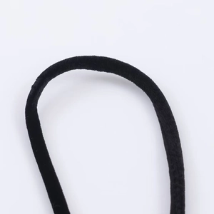 Macro shot of high-elasticity black velvet fabric detail on a luxury hair accessory