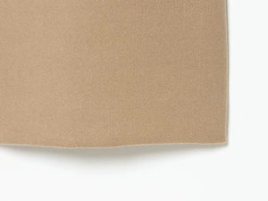 Macro detail of camel wool blend fabric showing high-quality fiber texture and smooth edges