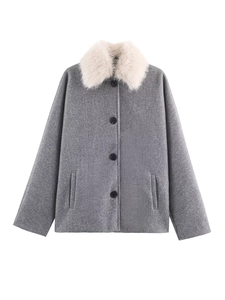 Close-up of fluffy white faux fur collar on the elegant grey wool coat for women