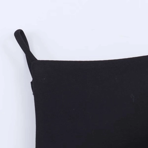 Close-up detail of smooth black fabric texture and neat stitching on a summer camisole