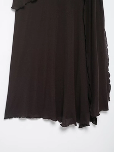 Detailed close-up of dark brown knit skirt featuring elegant lettuce trim wavy edges