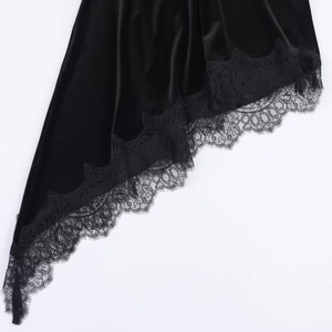 Detailed view of the irregular satin hemline featuring delicate black eyelash lace trim