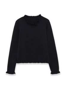 Detail of delicate ruffle edges on a black long-sleeve knit sweater with soft texture